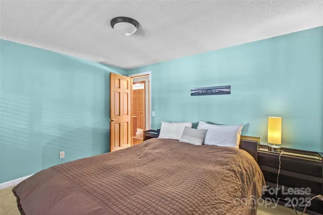 a bedroom with a bed and chair