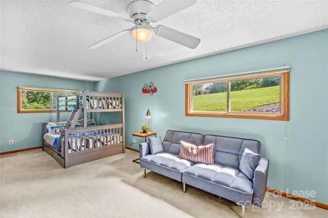 a bedroom with furniture and a large window