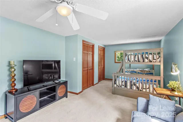 a bedroom with furniture and a flat screen tv