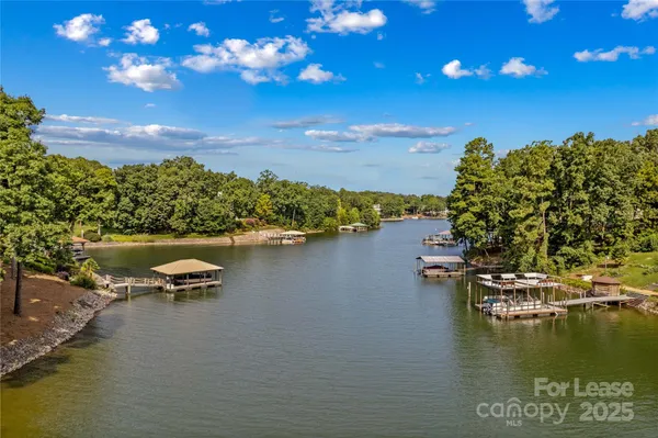a view of a lake with lawn chairs