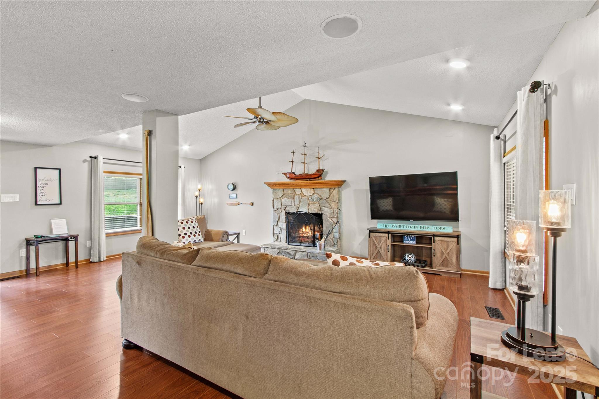 173 Waddell Road Mooresville, NC 28117 - Photo 10 of 47 a living room with furniture a flat screen tv and a fireplace