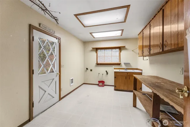 a kitchen with a cabinets and white appliances