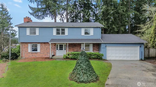 a front view of a house with a garden and plants