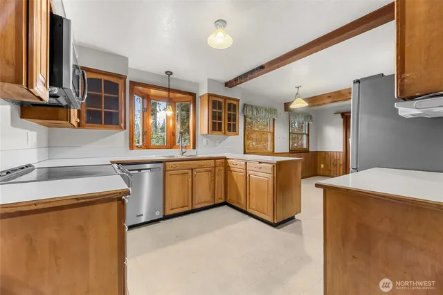 a kitchen with a sink stove and cabinets