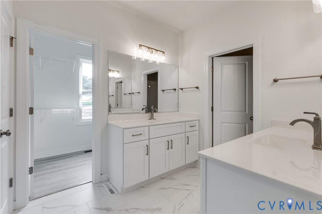 1393 Broad St Road Oilville, VA 23129 - Photo 25 of 39 Full bathroom with two vanities and light marble f
