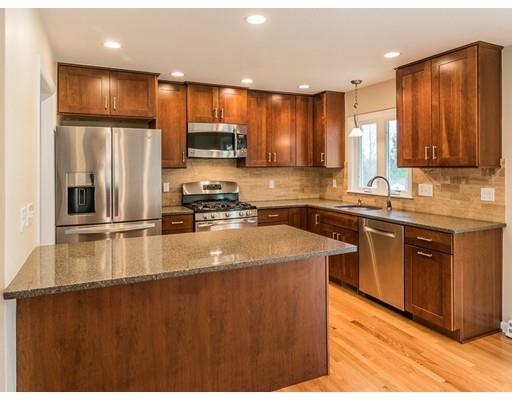 18 Pamela Road Framingham, MA 01701 - Photo 2 of 20 a kitchen with stainless steel appliances granite countertop a sink a stove a refrigerator cabinets and a kitchen island