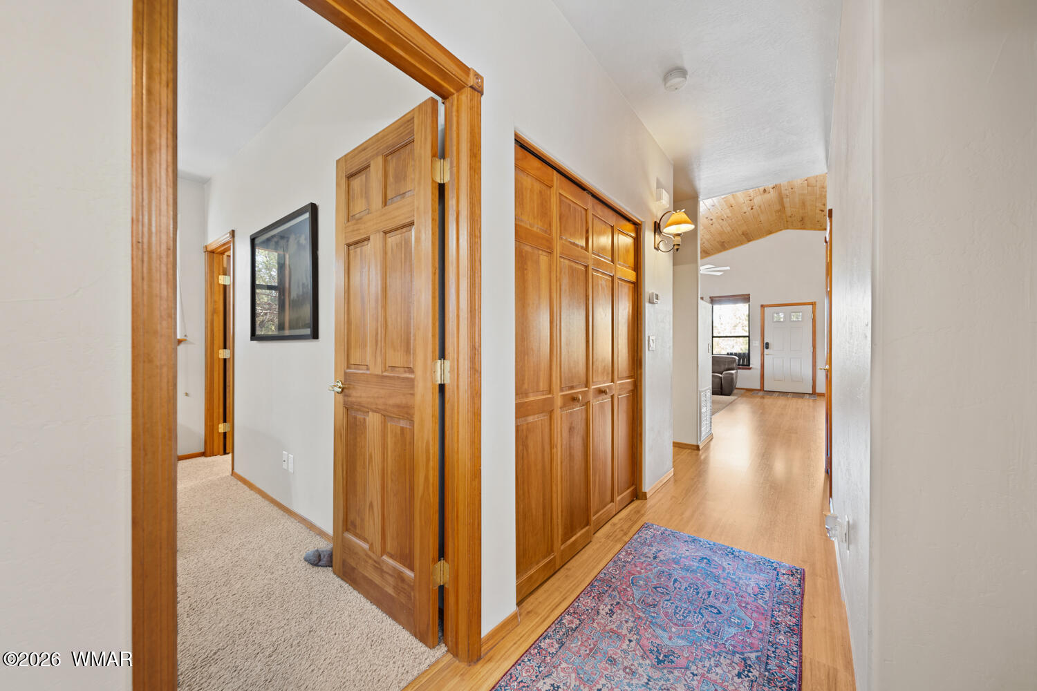 1041 South Pinon Circle Show Low, AZ 85901 - Photo 14 of 29 a view of a hallway with wooden floor and cabinets