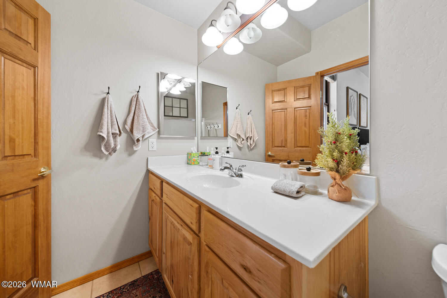 1041 South Pinon Circle Show Low, AZ 85901 - Photo 18 of 29 a bathroom with a sink a vanity and a mirror