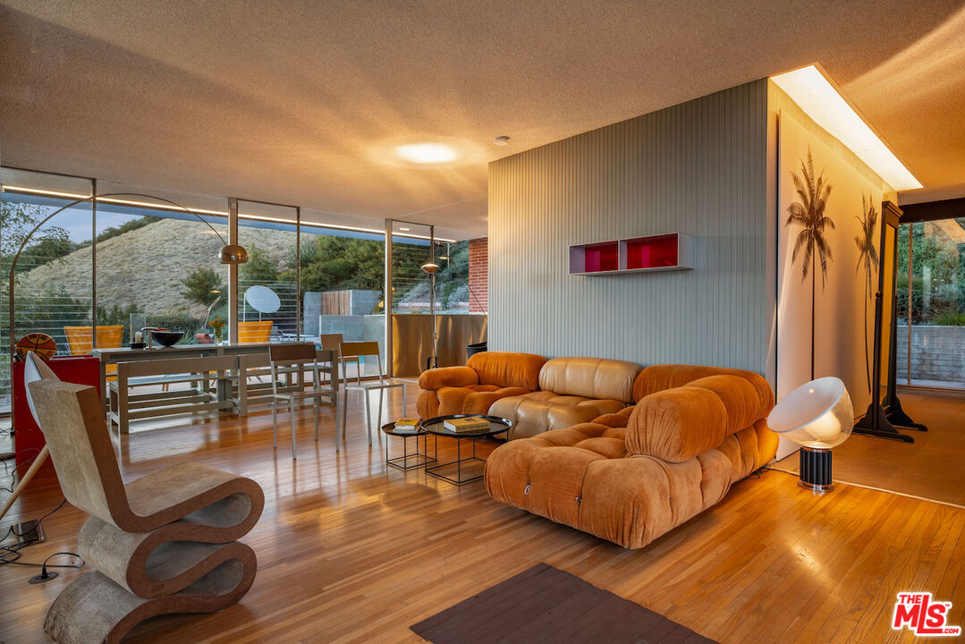 1531 North Tigertail Road Los Angeles, CA 90049 - Photo 13 of 24 a living room with furniture a rug and a floor to ceiling window