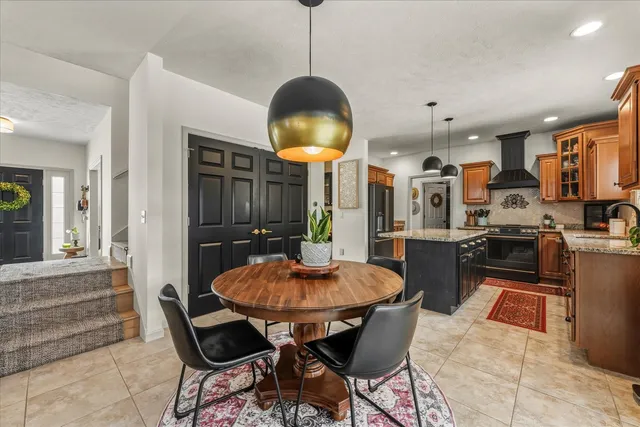 a kitchen with stainless steel appliances granite countertop a stove a sink and a refrigerator