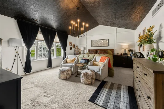 a bedroom with a bed and a view of living room