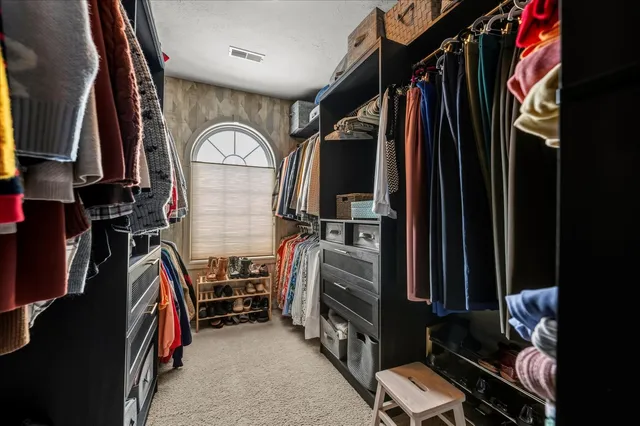 a bathroom with a tub a sink and a large mirror