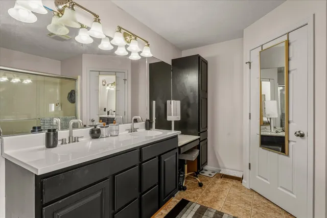 a bedroom with furniture and a large window