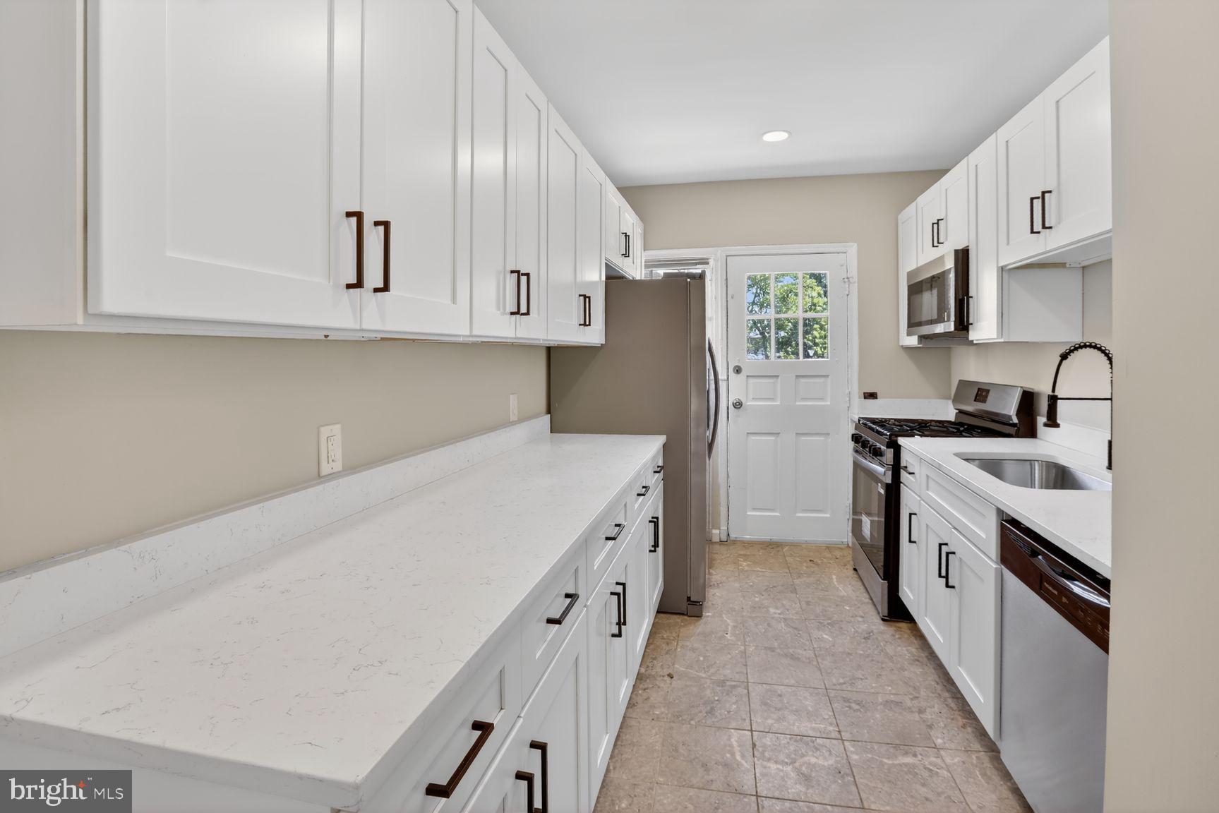 315 East Cold Spring Lane Baltimore, MD 21212 - Photo 5 of 25 a kitchen with cabinets and stainless steel appliances