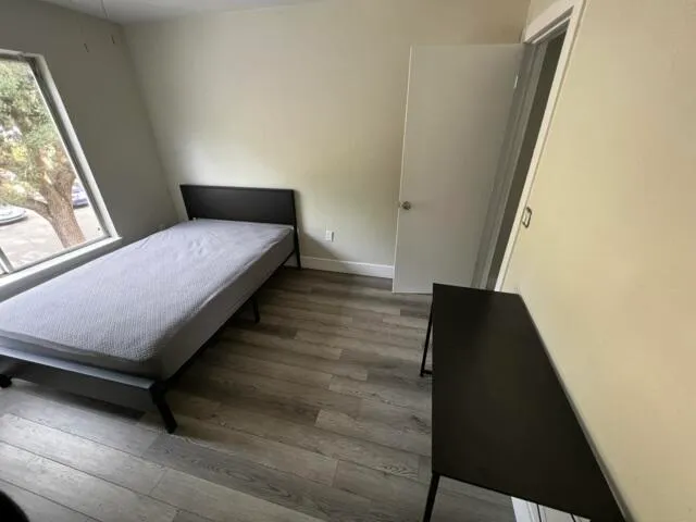 a bedroom with a bed and a table