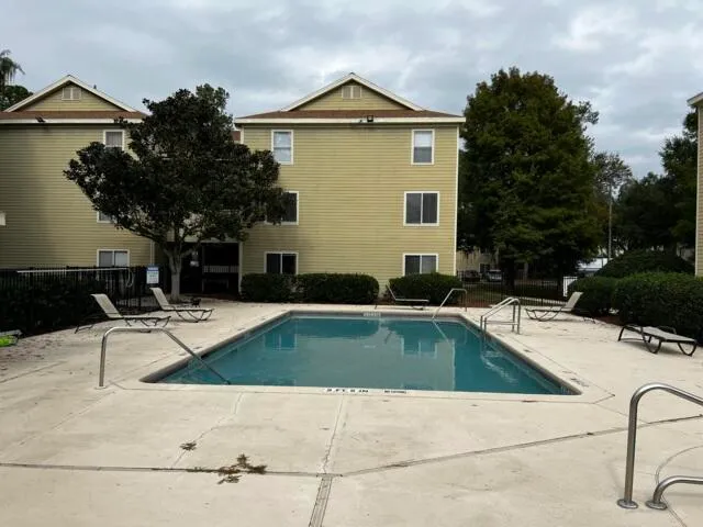 a view of a house with swimming pool and sitting area