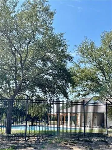 a view of a building with a swimming pool and sitting area