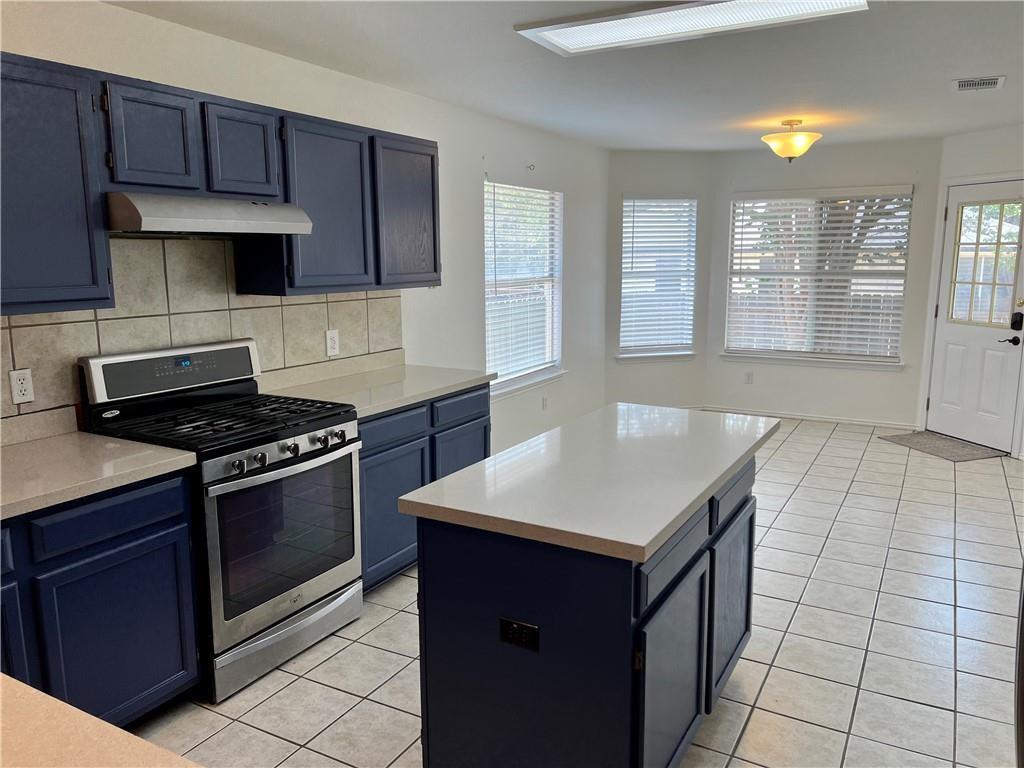 17312 Manish Drive Pflugerville, TX 78660 - Photo 5 of 19 a kitchen with a stove cabinets and a refrigerator