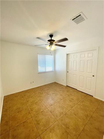 17312 Manish Drive Pflugerville, TX 78660 - Photo 6 of 19 an empty room with a ceiling fan and window