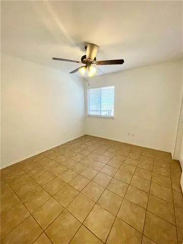 a view of a room with a chandelier fan and windows