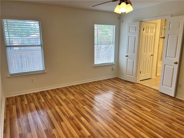 17312 Manish Drive Pflugerville, TX 78660 - Photo 10 of 19 an empty room with wooden floor closet and windows