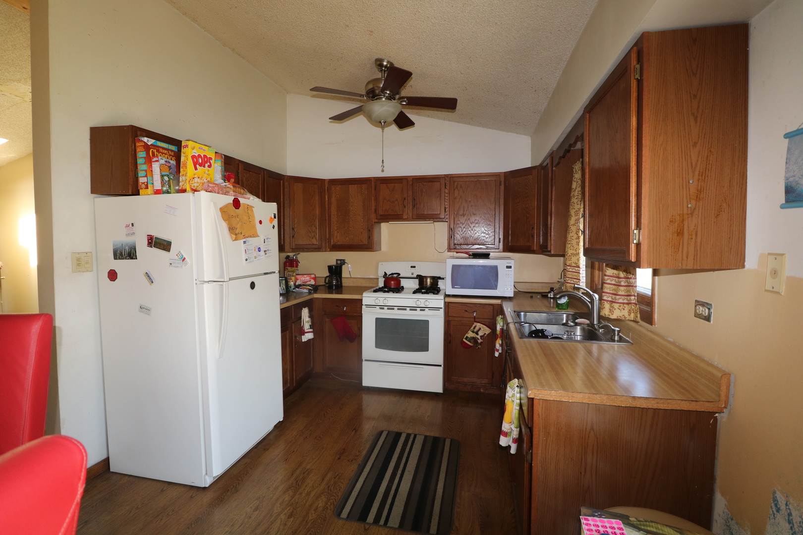 589 Redwood Road Bolingbrook, IL 60440 - Photo 4 of 18 a kitchen with a refrigerator a stove top oven a sink and dishwasher