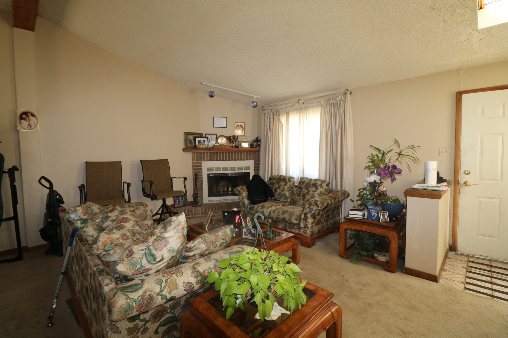 589 Redwood Road Bolingbrook, IL 60440 - Photo 5 of 18 a living room with furniture a fireplace and decor