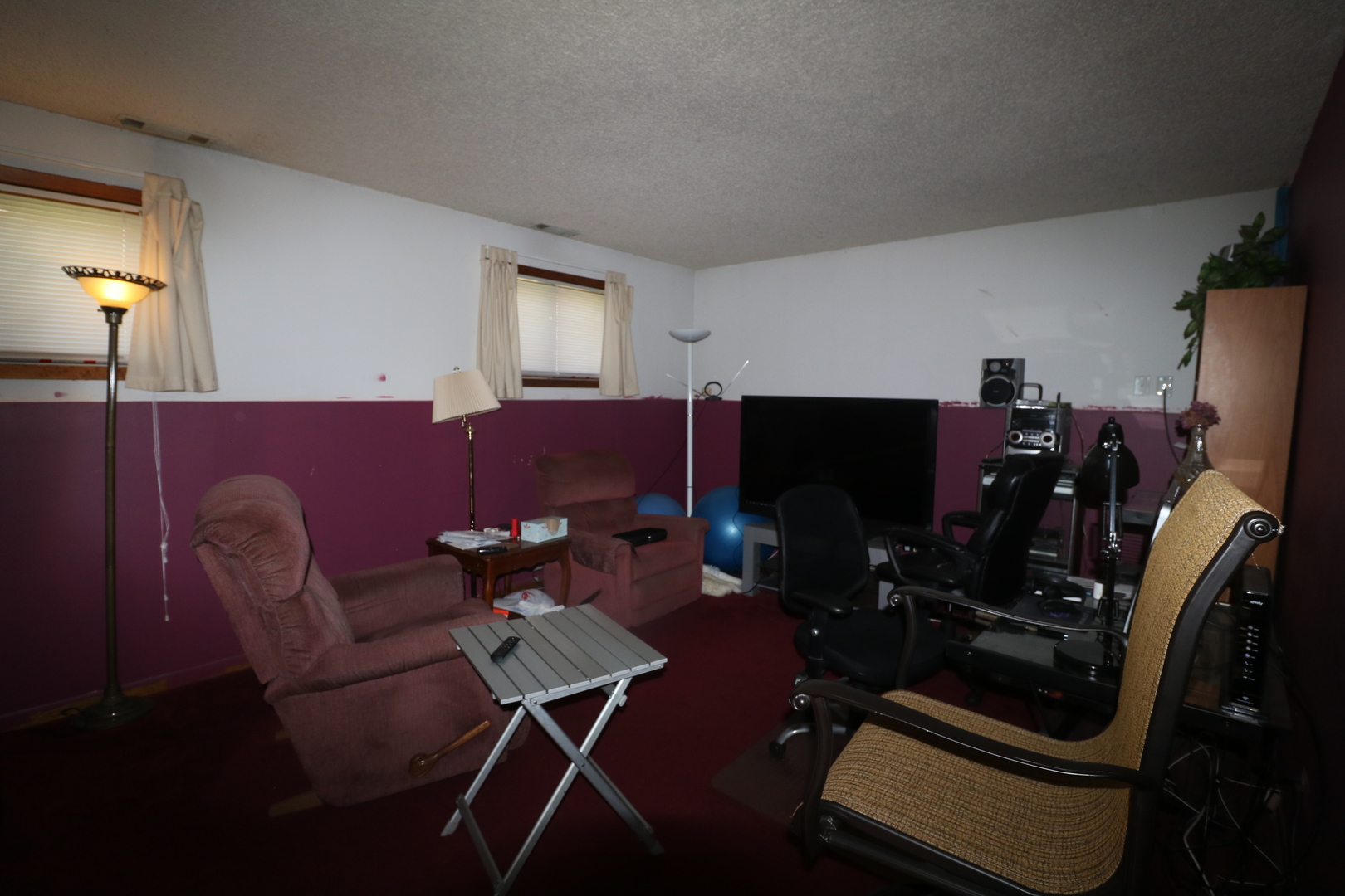 589 Redwood Road Bolingbrook, IL 60440 - Photo 10 of 18 a living room with furniture a flat screen tv and gym equipment