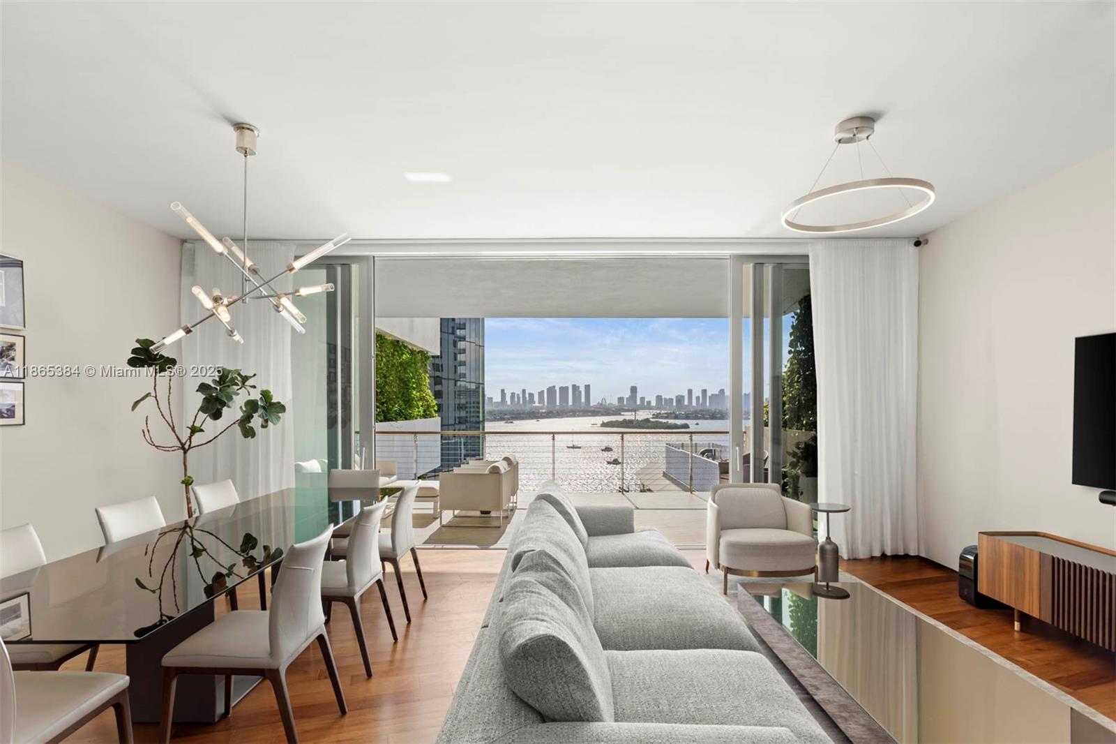 1300 Monad Terrace, Unit 11C Miami Beach, FL 33139 - Photo 1 of 29 a living room with furniture a chandelier and a fireplace