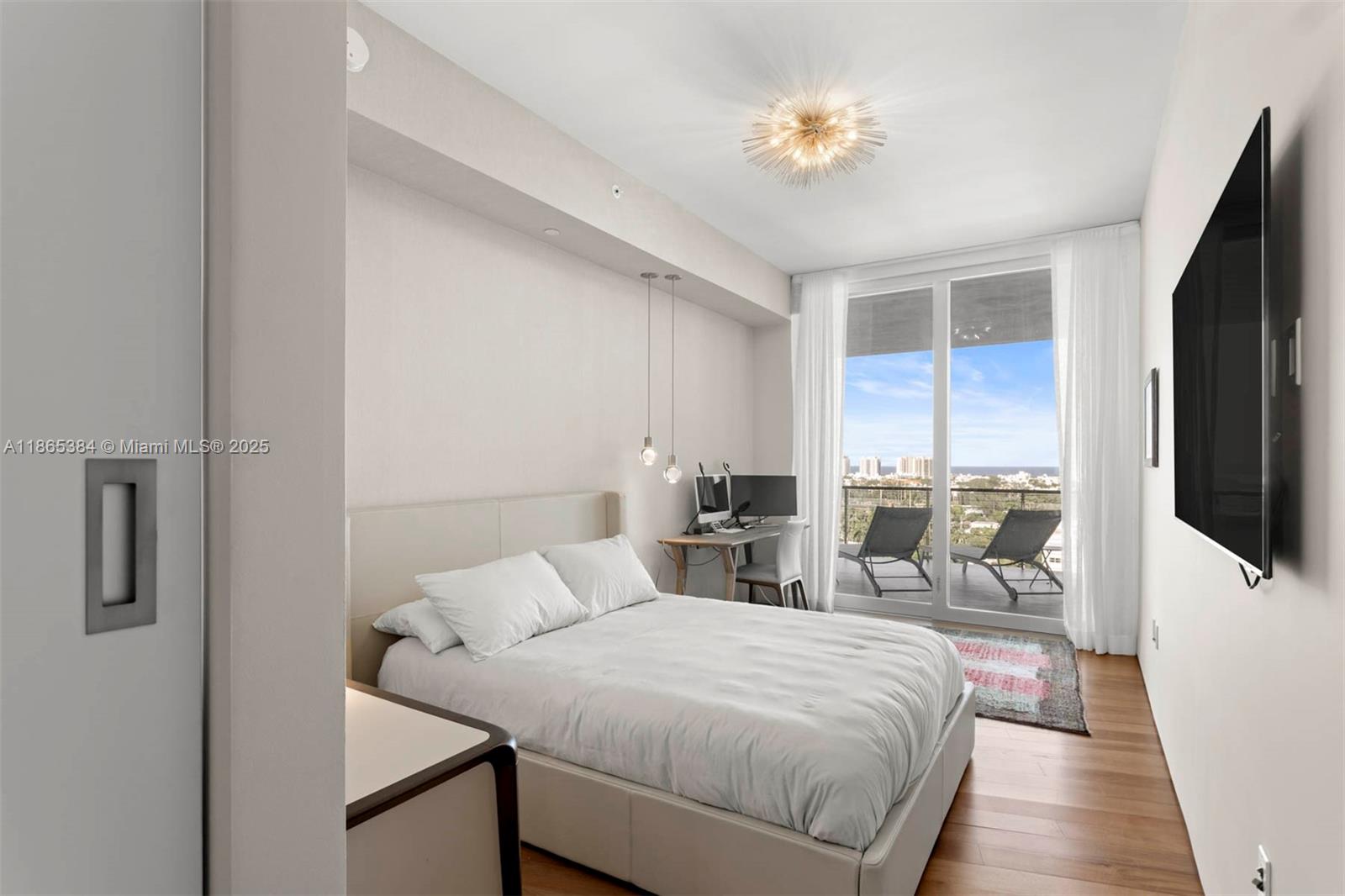 1300 Monad Terrace, Unit 11C Miami Beach, FL 33139 - Photo 15 of 29 a bedroom with a bed and a flat tv screen on dresser