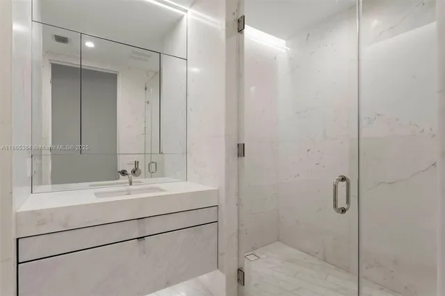 a bathroom with a shower sink and mirror