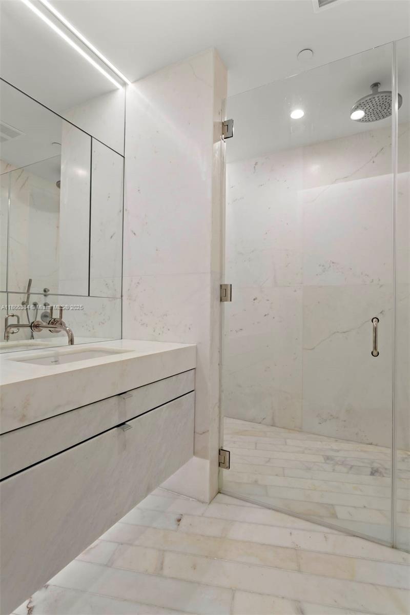 1300 Monad Terrace, Unit 11C Miami Beach, FL 33139 - Photo 17 of 29 a bathroom with a shower sink and mirror