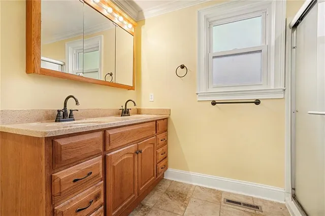 a bathroom with a sink a mirror and a window