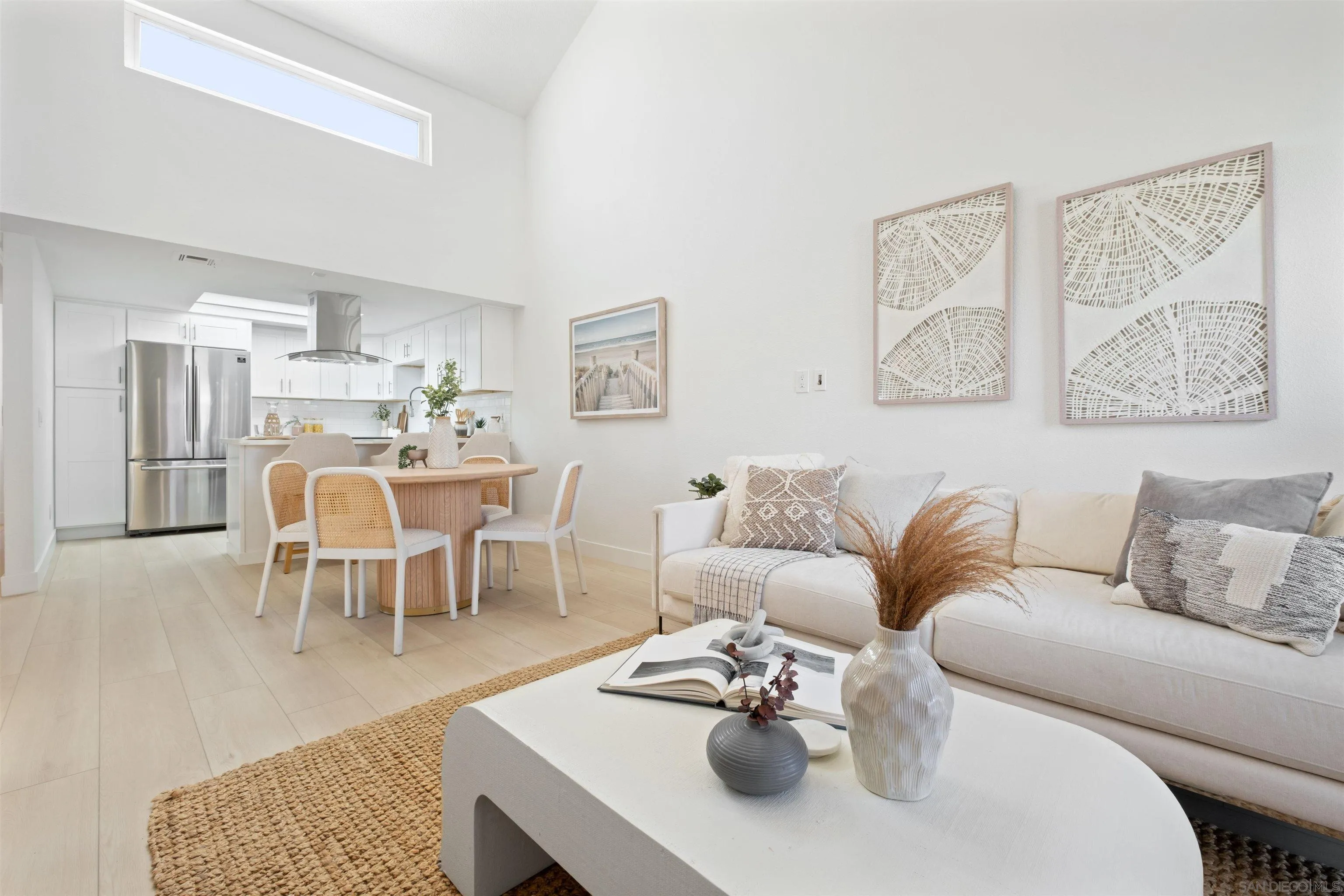 a living room with furniture kitchen view and a dining table