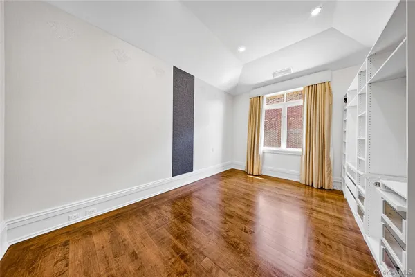 a bathroom with a granite countertop sink a toilet a large mirror and bathtub