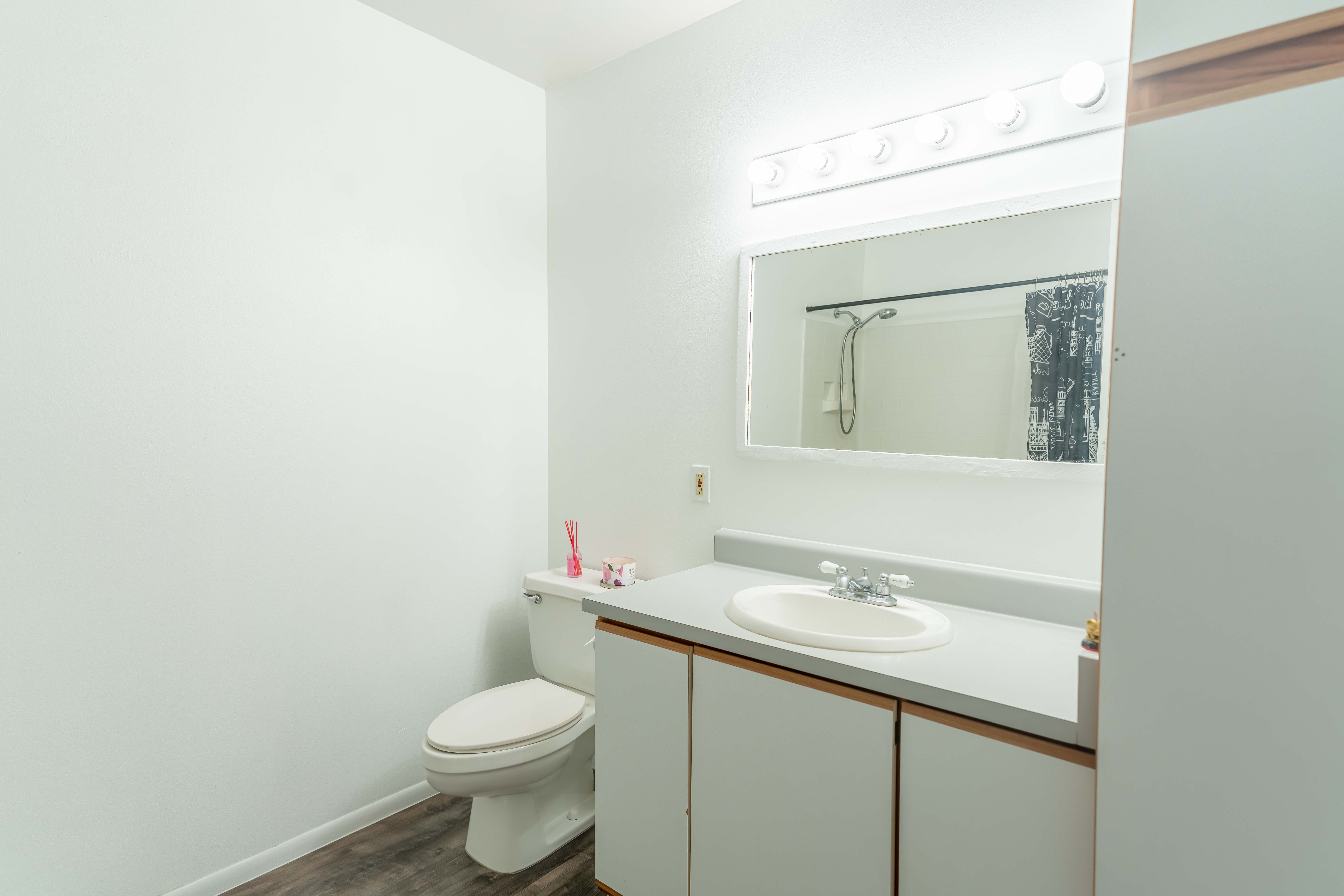 68-3831 Lua Kula Street, Unit L107 Waikoloa, HI 96738 - Photo 7 of 17 a bathroom with a toilet sink and mirror