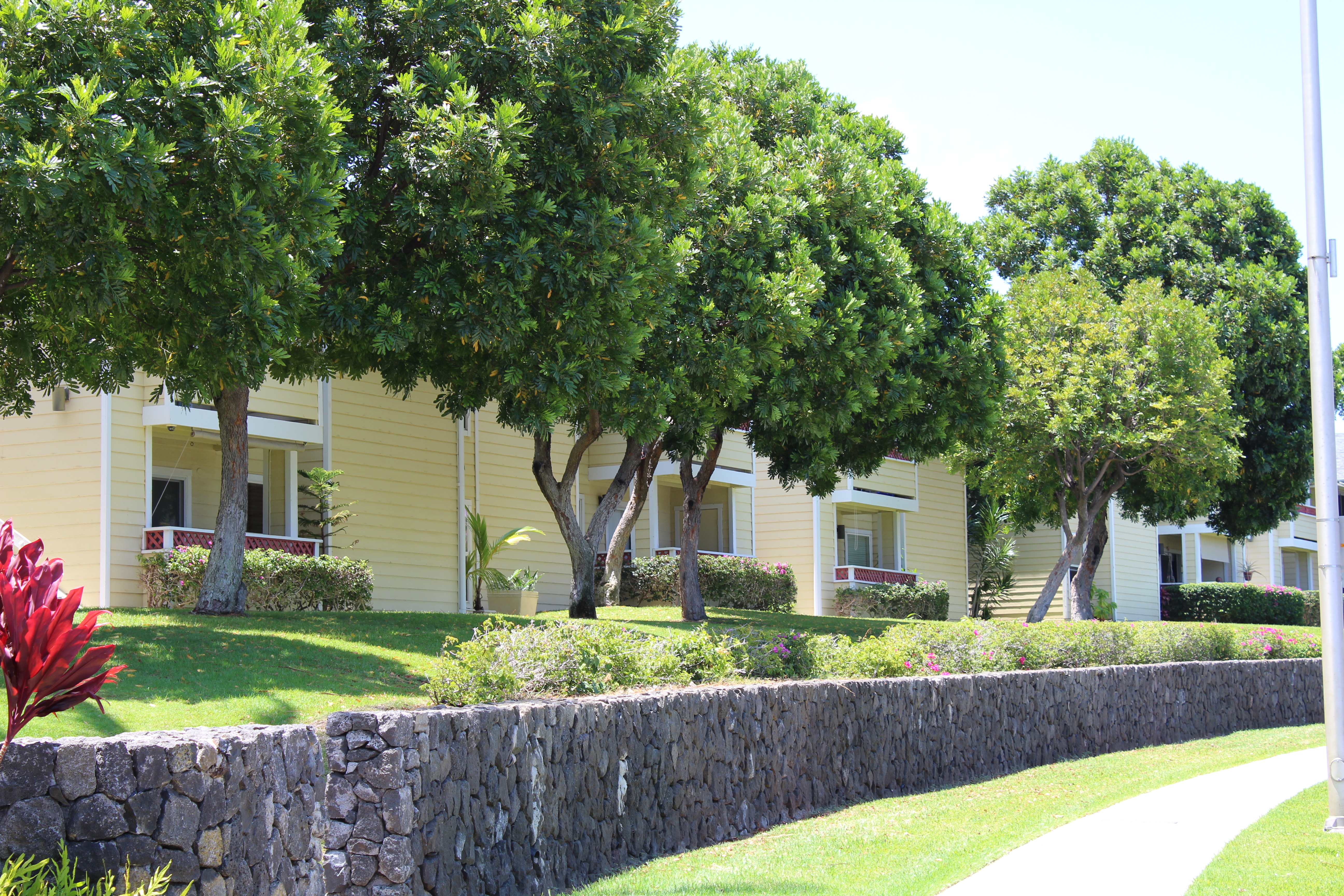 68-3831 Lua Kula Street, Unit L107 Waikoloa, HI 96738 - Photo 10 of 17 a front view of a house with a yard and a garden