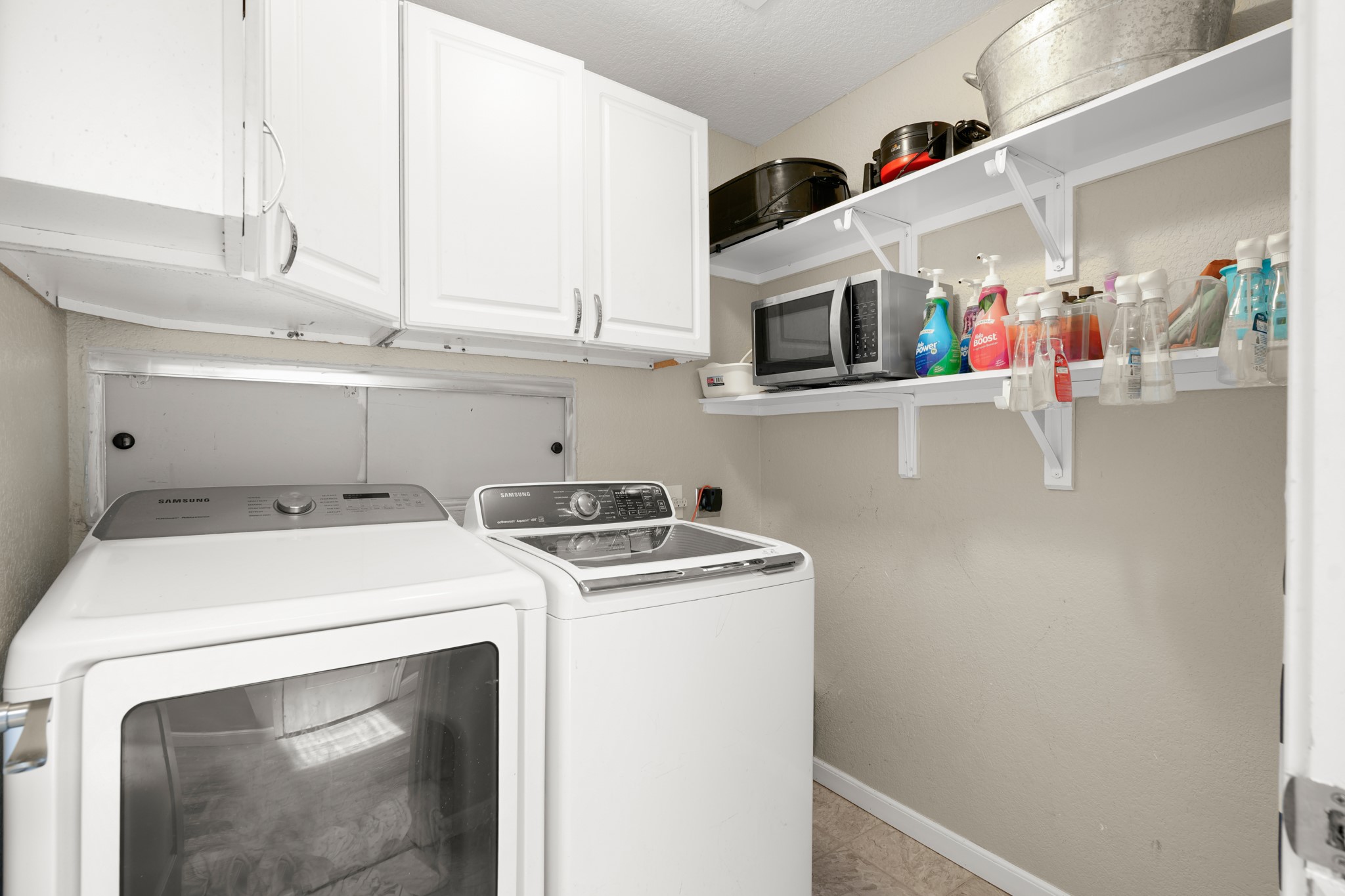 9725 Bock Road Buda, TX 78610 - Photo 24 of 32 Ample storage and modern appliances elevate this functional laundry space.
