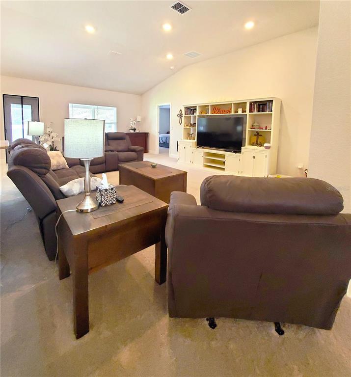 10170 Southwest 78th Court Ocala, FL 34476 - Photo 16 of 43 a living room with furniture and a flat screen tv