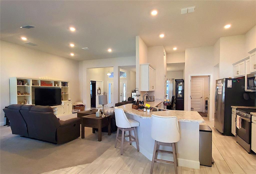 10170 Southwest 78th Court Ocala, FL 34476 - Photo 18 of 43 a living room with fireplace furniture and a flat screen tv