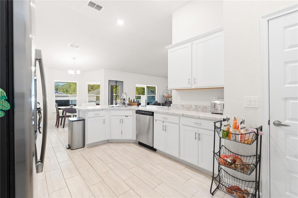 10170 Southwest 78th Court Ocala, FL 34476 - Photo 20 of 43 a kitchen with a refrigerator and white cabinets