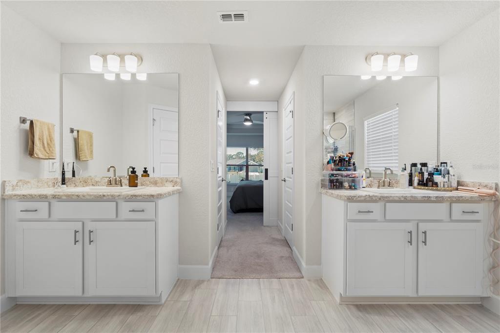 10170 Southwest 78th Court Ocala, FL 34476 - Photo 28 of 43 a en suite bathroom with a double vanity sink and a mirror