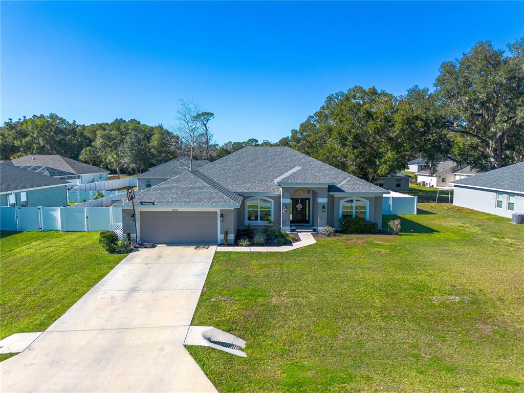 10170 Southwest 78th Court Ocala, FL 34476 - Photo 34 of 43 a front view of a house with a yard