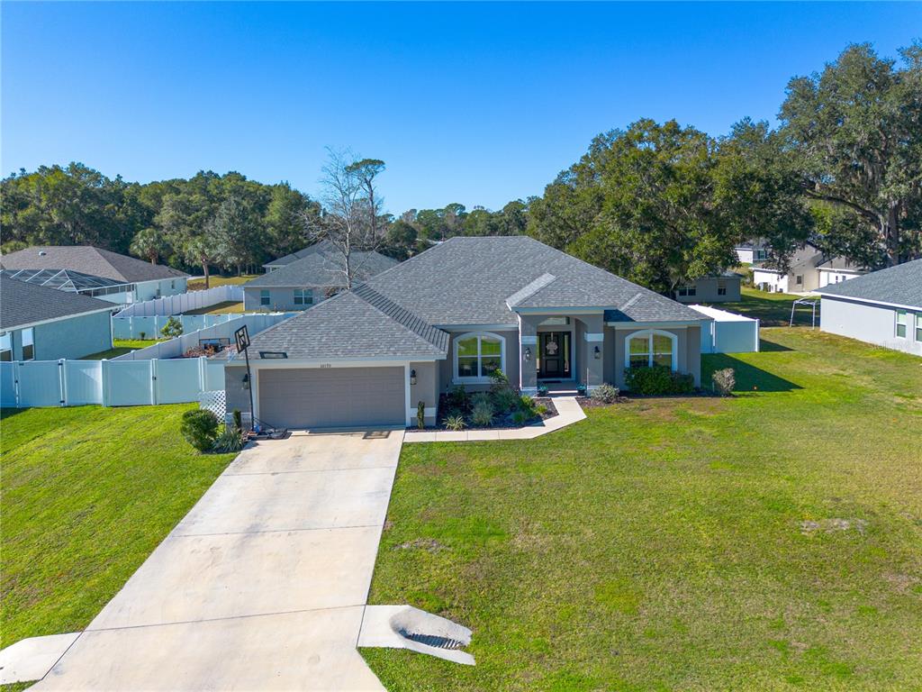 10170 Southwest 78th Court Ocala, FL 34476 - Photo 36 of 44 a front view of a house with a yard