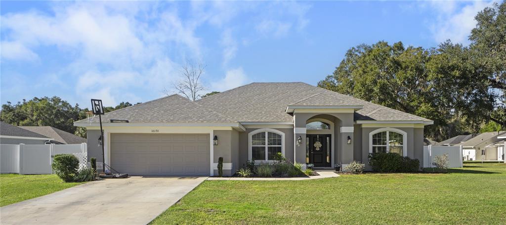 10170 Southwest 78th Court Ocala, FL 34476 - Photo 42 of 43 a front view of a house with a yard