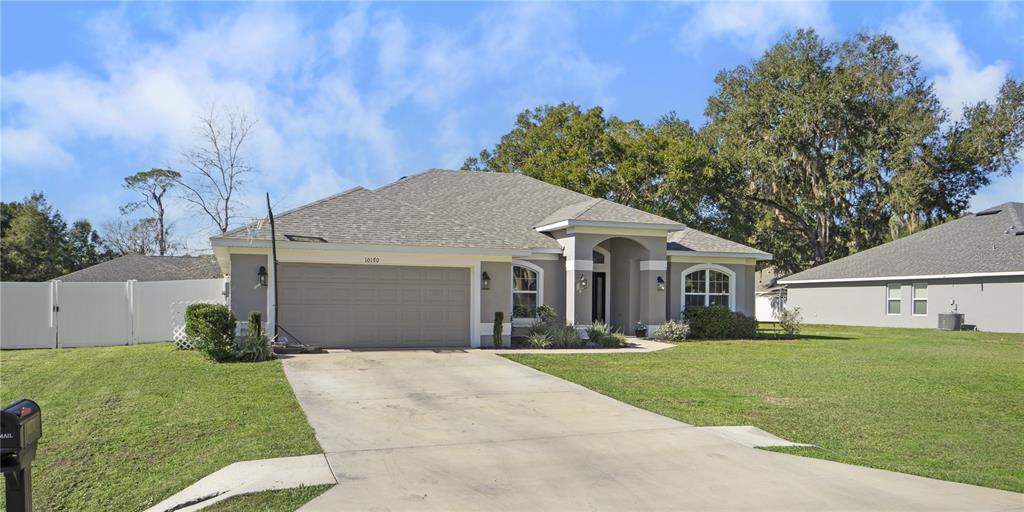 10170 Southwest 78th Court Ocala, FL 34476 - Photo 43 of 43 a front view of a house with a yard and garage