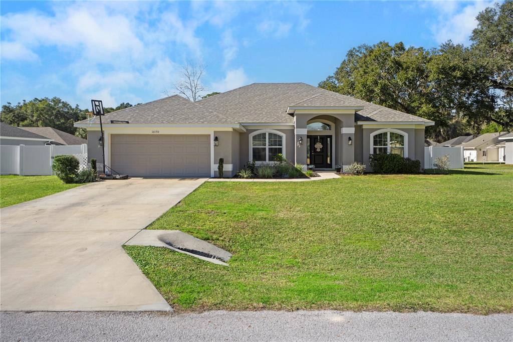 10170 Southwest 78th Court Ocala, FL 34476 - Photo 5 of 44 a front view of a house with yard and green space