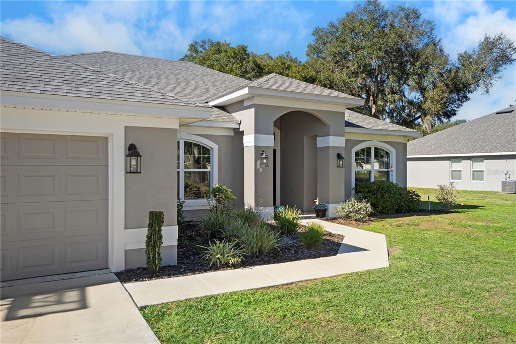 10170 Southwest 78th Court Ocala, FL 34476 - Photo 6 of 44 a front view of a house with a yard