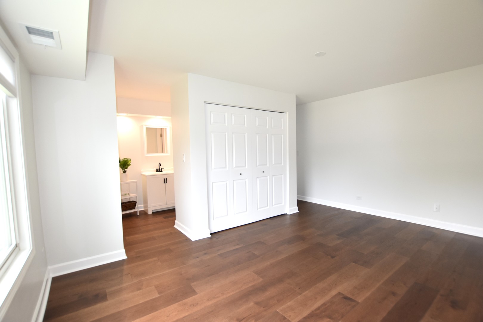 500 West Huntington Commons Road, Unit 157 Mount Prospect, IL 60056 - Photo 15 of 24 a view of a room with wooden floor and a window