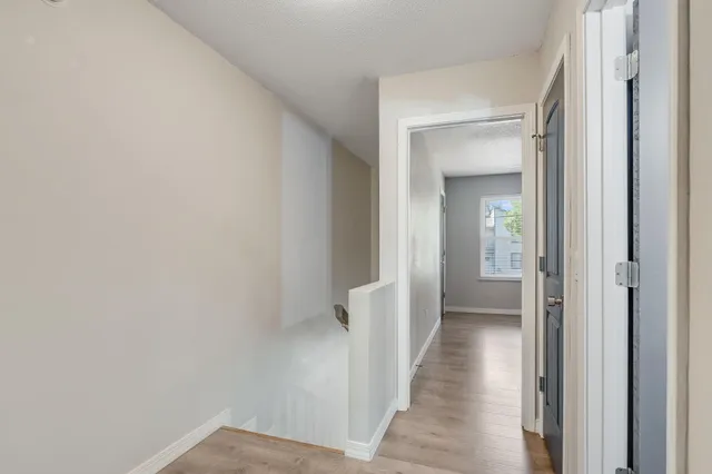 a view of a hallway with a wooden floor